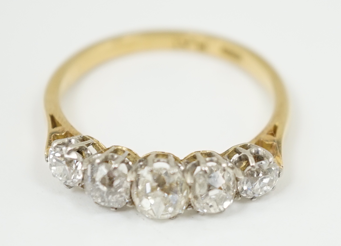 An early to mid 20th century 18ct gold, platinum and graduated five diamond set half hoop ring